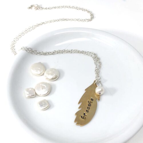 Handstamped feather in brass with pearl charm