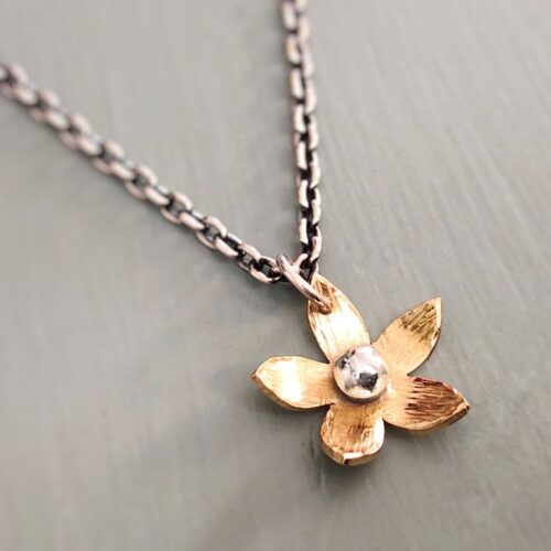 Tiny brass flower with sterling silver chain