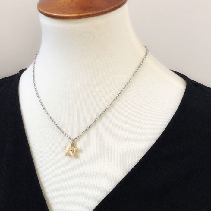 Tiny brass flower with sterling silver chain